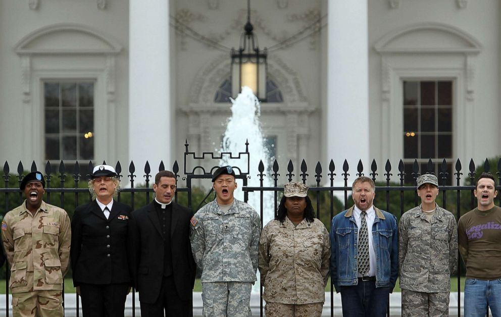 PHOTO: Gay rights activists and gay veterans, including former Army Lieutenant Dan Choi (4th L) and former Marine Corporal Evelyn Thomas (5th L), handcuff themselves to the fence of the White House during a protest Nov. 15, 2010 in Washington, DC.
