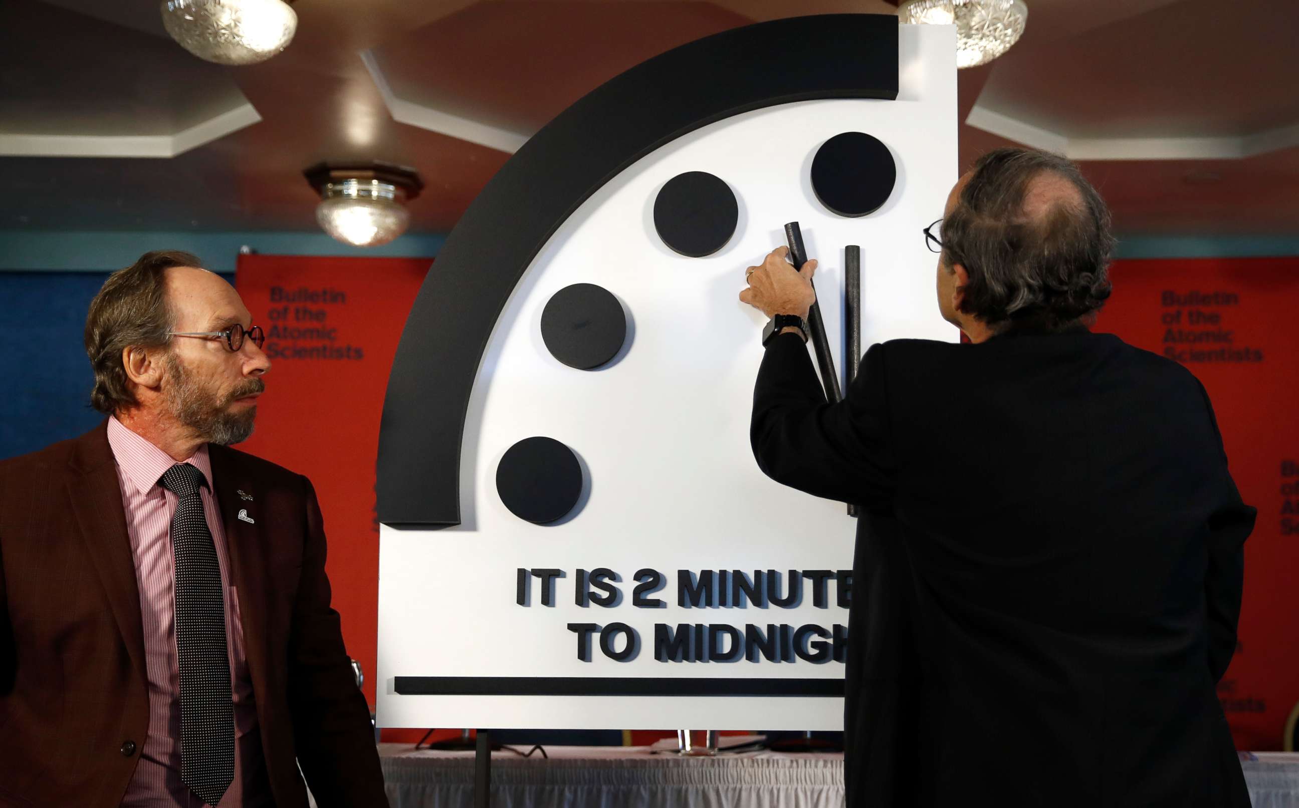 PHOTO: Robert Rosner, right, joined by Bulletin of the Atomic Scientists member Lawrence Krauss, left, moves the minute hand of the Doomsday Clock to two minutes to midnight during a news conference at the National Press Club in Washington, Jan. 25, 2018.