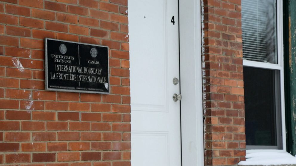 PHOTO: A sign marking the international boundary is seen on a building that sits on the U.S.-Canada border in Derby Line, Vermont and Stanstead, Quebec.