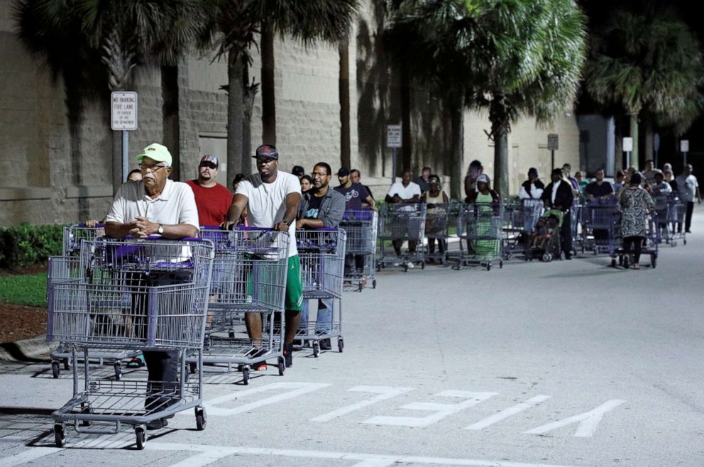 PHOTO: Shoppers wait in a long line for a Sam's Club store to open before sunrise, as people rushed to buy supplies ahead of the arrival of Hurricane Dorian in Kissimmee, Florida, U.S. August 30, 2019.