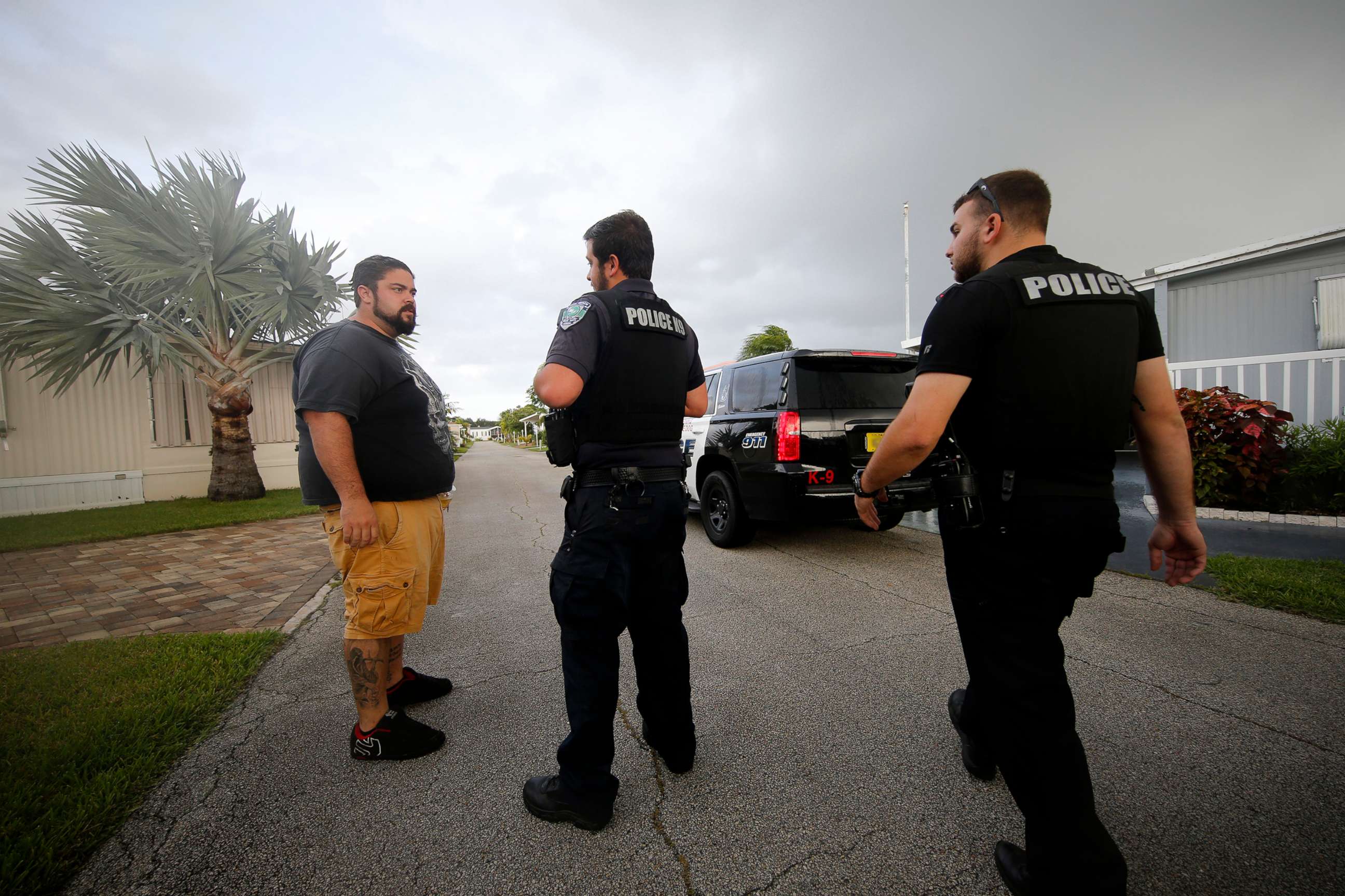 PHOTO: Vero Beach police officers talk to resident Todd Dufresne, left, as they notify residents of a trailer park community of a mandatory evacuation, in preparation for Hurricane Dorian, in Vero Beach, Fla., Sept. 2, 2019.