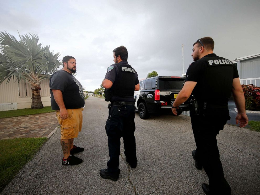 PHOTO: Vero Beach officers speak to Todd Dufresne, a resident on the left, while they warn residents of a mobile home park of a mandatory evacuation in anticipation of the hurricane Dorian, Vero Beach, Florida, September 2, 2019.