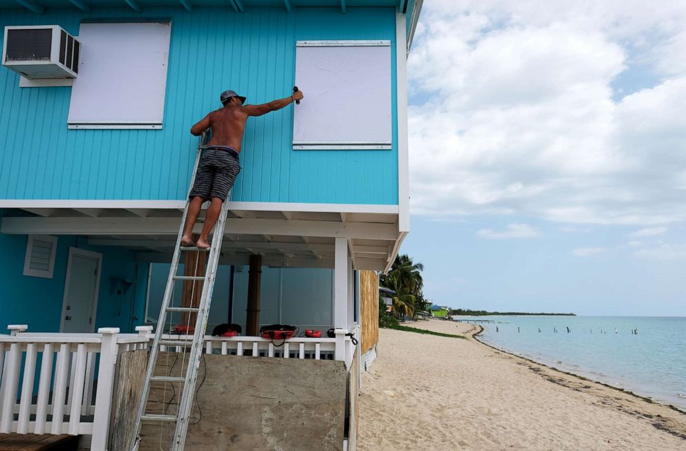 PHOTO: A man boards up a window of a beach house in the tourist zone of El Combate as Tropical Storm Dorian approaches in Cabo Rojo, Puerto Rico, Aug. 27, 2019.  