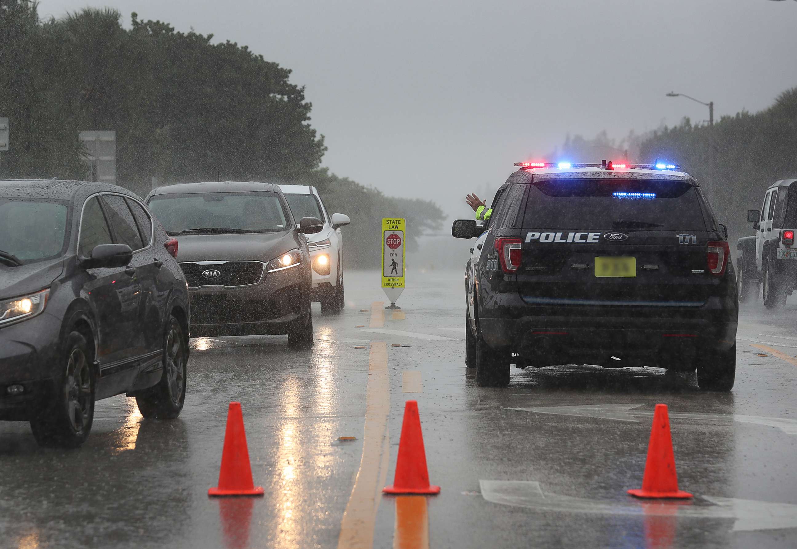 PHOTO: A Highland Beach police officer sits in his vehicle to check id's of people in cars as he only allows residents to enter the Highland Beach area as Hurricane Dorian continues to make its way toward the Florida coast, Sept. 2, 2019.