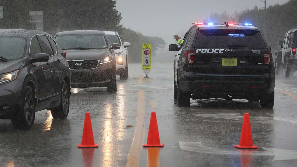 PHOTO: A Highland Beach police officer sits in his vehicle to check id's of people in cars as he only allows residents to enter the Highland Beach area as Hurricane Dorian continues to make its way toward the Florida coast, Sept. 2, 2019.