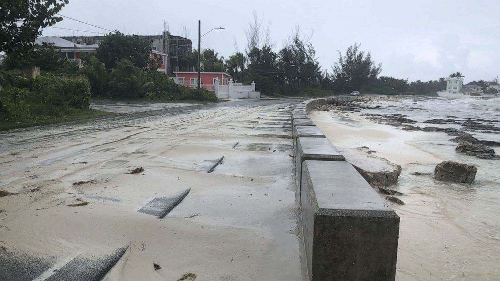 PHOTO: Sand pours on to a road near the beach during the approach of Hurricane Dorian, Sept. 1, 2019, in Nassau, Bahamas. 