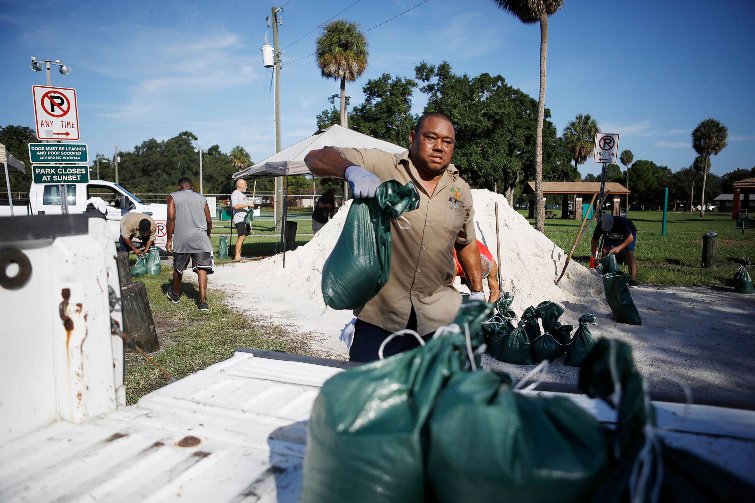 PHOTO: City of Tampa Parks & Recreation employee Rod McKinney helps Horace Whittington 61, of Tampa load sandbags in his truck for his mother 91-year-old mother in preparation for Hurricane Dorian at MacFarlane Park in Tampa, Fla., Aug. 29, 2019.
