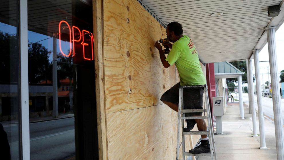 PHOTO: A man boards up a business ahead of the arrival of Hurricane Dorian in Cocoa, Fla., Sept. 1, 2019.  