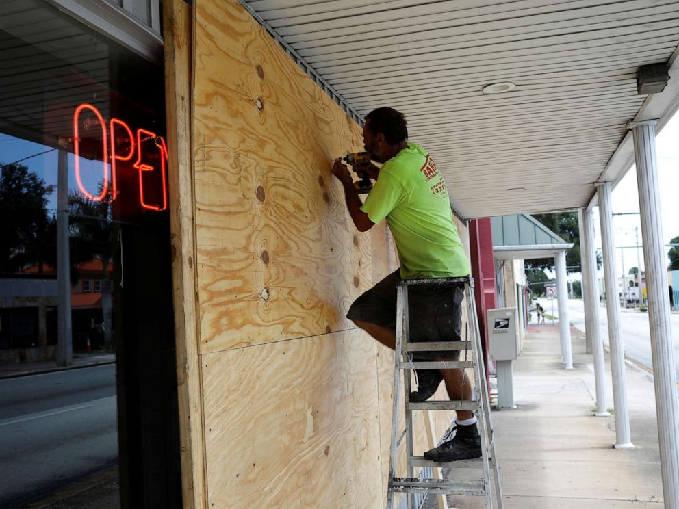 PHOTO: A man boards up a business ahead of the arrival of Hurricane Dorian in Cocoa, Fla., Sept. 1, 2019.