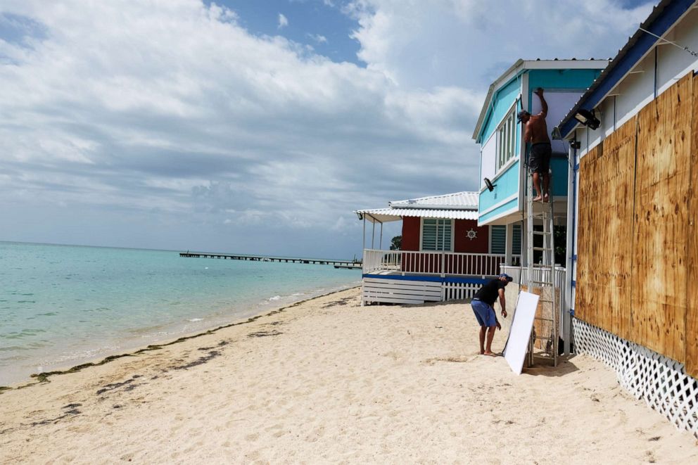 PHOTO: A man boards up the windows of a beach house in the tourist zone of El Combate as Tropical Storm Dorian approaches in Cabo Rojo, Puerto Rico, Aug. 27, 2019.