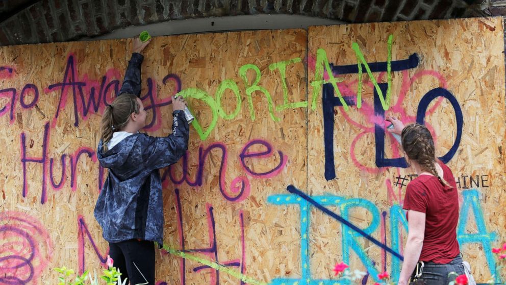 PHOTO: Coreyanna Moore and Madison Moore of Charleston add Dorian's name to their hurricane defenses ahead of the arrival of Hurricane Dorian in Charleston, S.C., Sept. 4, 2019.