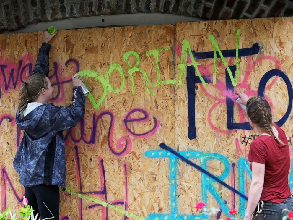 PHOTO: Coreyanna Moore and Madison Moore of Charleston add Dorians name to their hurricane defenses ahead of the arrival of Hurricane Dorian in Charleston, S.C., Sept. 4, 2019.