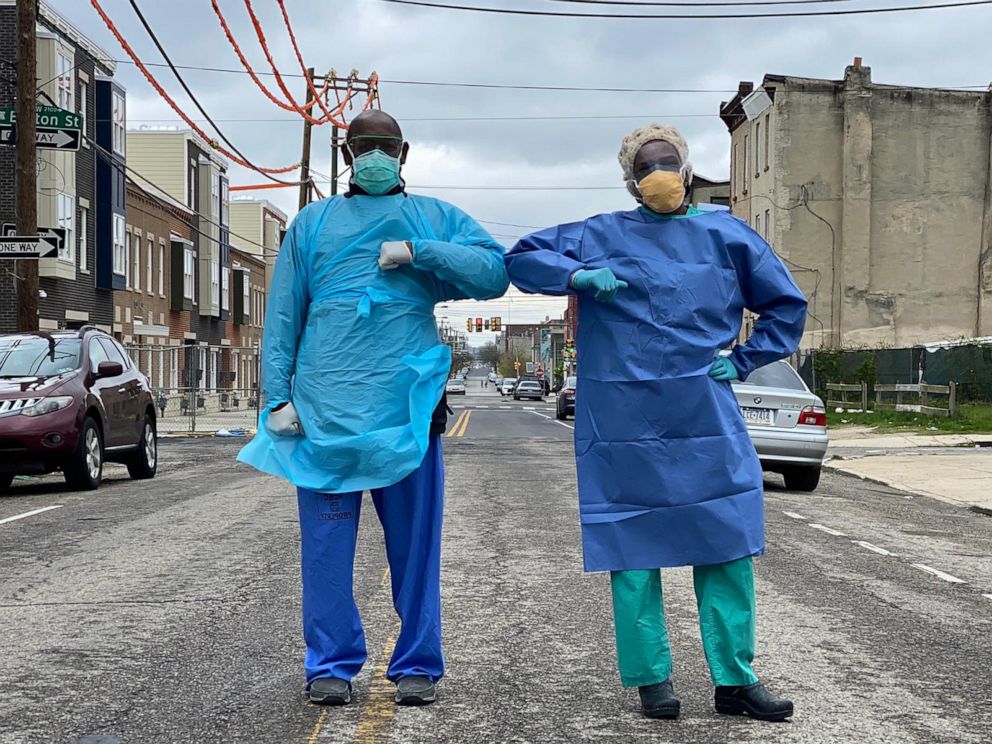 PHOTO: Dr. Ala Stanford stands on street with a colleague.