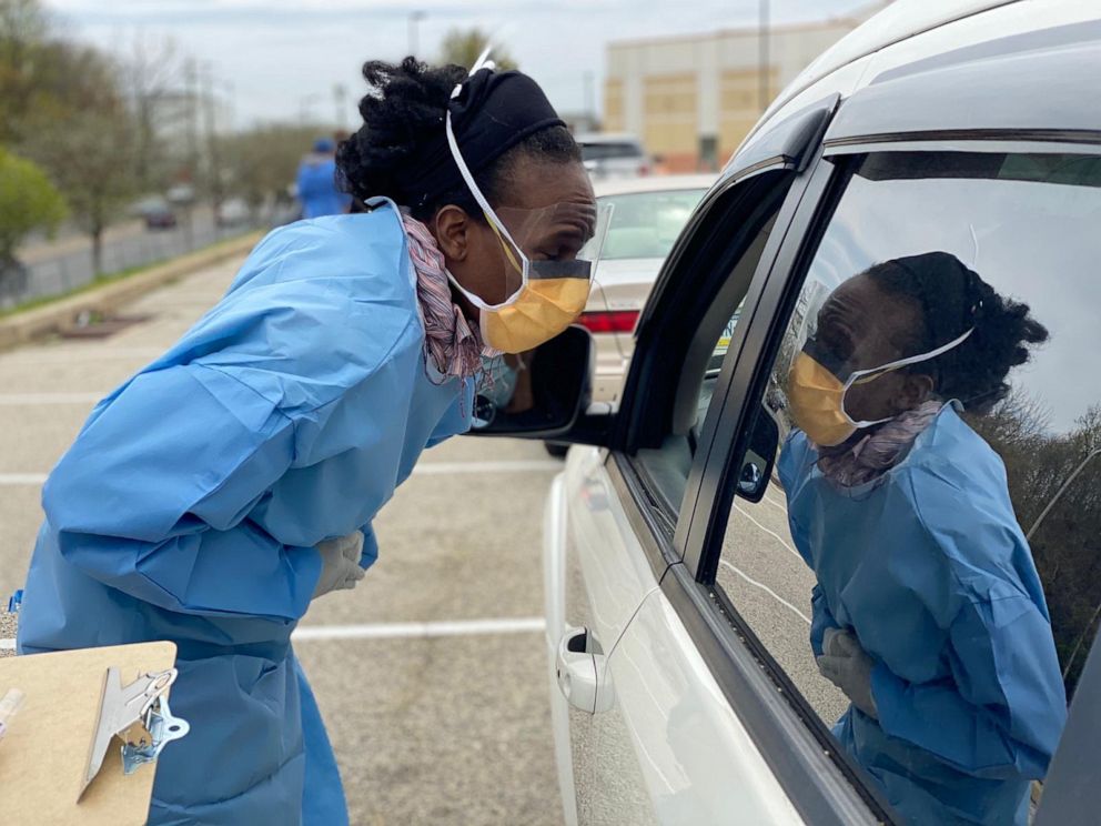 PHOTO: Dr. Ala Stanford leans into car to test an unidentified patient for COVID-19 in Philadelphia.