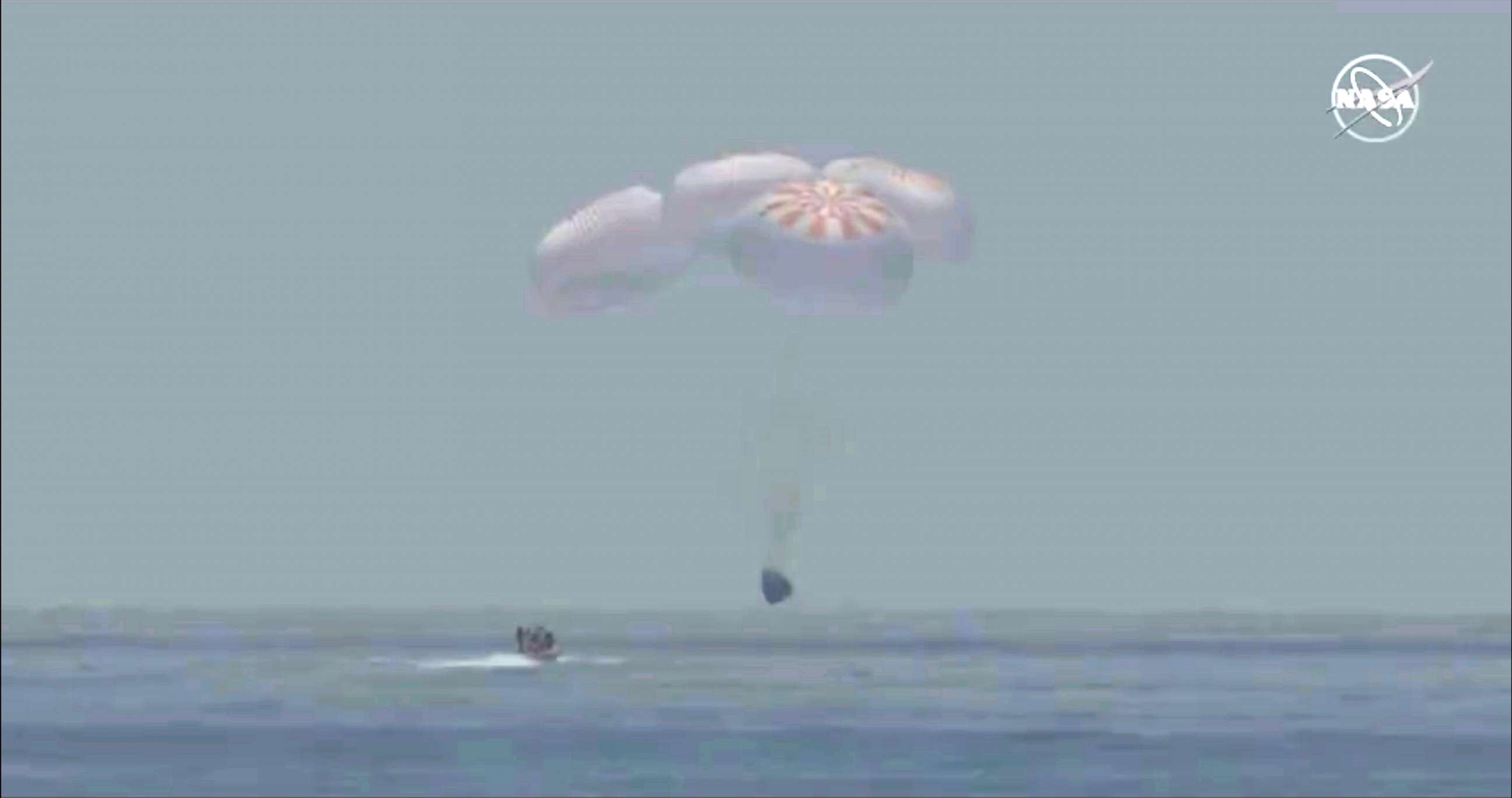 PHOTO: A capsule with NASA astronauts Robert Behnken and Douglas Hurley splashes down in the Gulf of Mexico, August 2, 2020.
