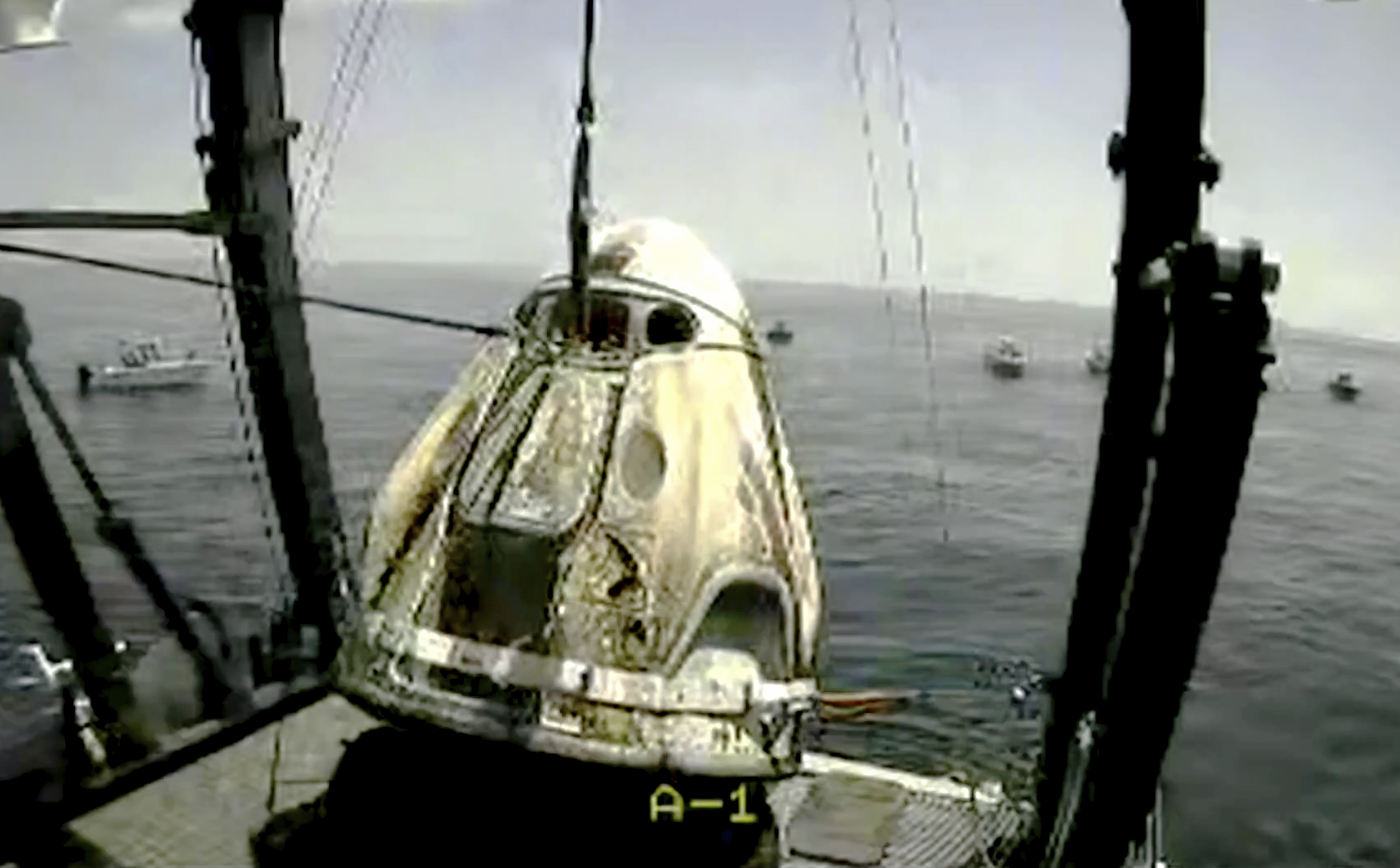 PHOTO: In this frame grab from NASA TV, the SpaceX capsule is lifted onto a ship, Aug. 2, 2020 in the Gulf of Mexico. 