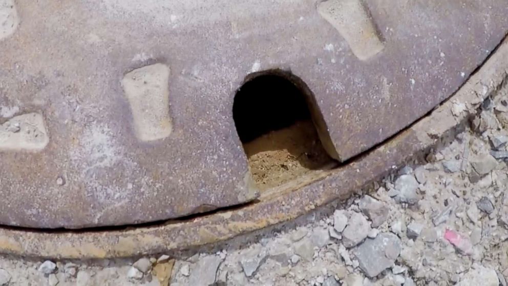 PHOTO: A finger of an 11-year-old boy poking through a manhole cover alerts rescuers to help save him from a drain pipe after he was swept away by floodwaters in Calumet County, Wis.