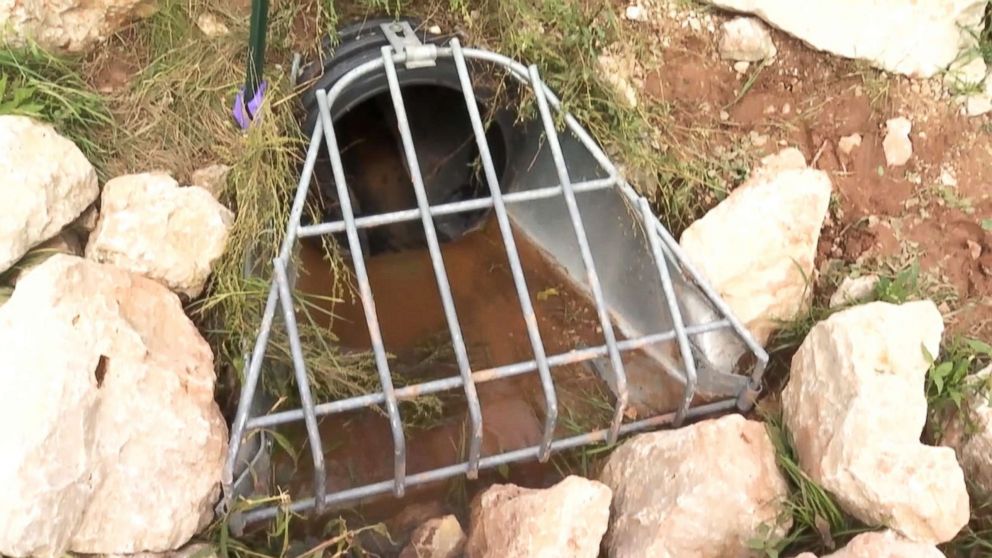 PHOTO: A finger of an 11-year-old boy poking through a manhole cover alerts rescuers to help save him from a drain pipe after he was swept away by floodwaters in Calumet County, Wis.