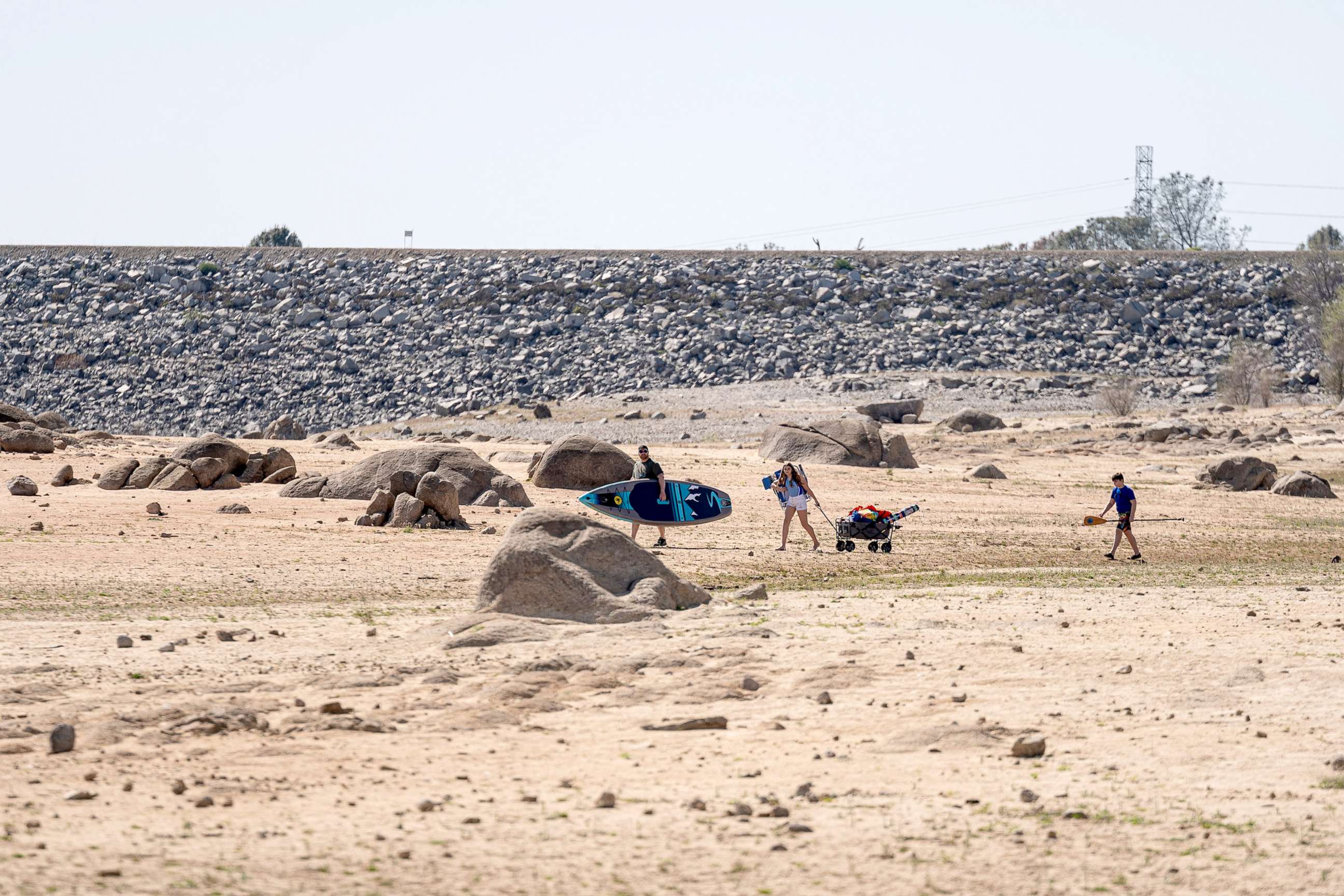 PHOTO: People walk over a dried lake bed at Folsom Lake in Folsom, Calif., March 31, 2021. Much of the U.S. West is facing the driest spring in seven years.