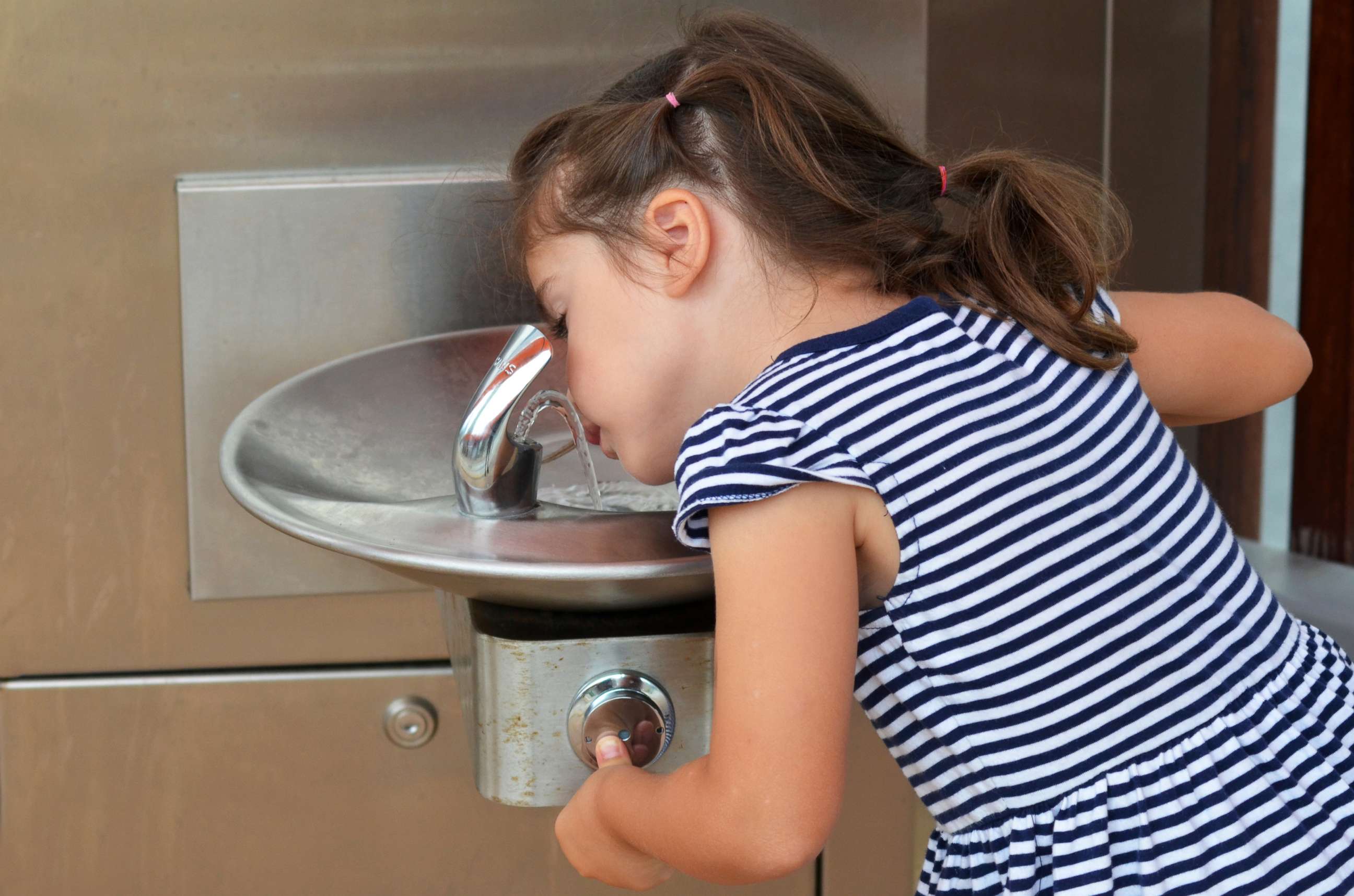 PHOTO: A girl drinks from a water fountain in an undated stock photo. 