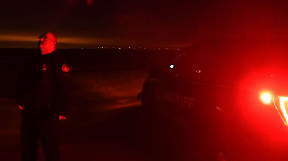 PHOTO: Lincoln County Sheriff Deputy Justin Allen stands outside of his squad car looking up at the night sky on Jan. 2, 2020 near Limon, Colo.
