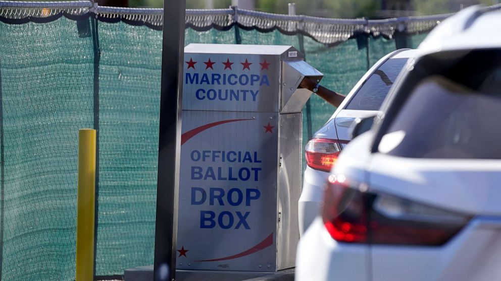PHOTO: A voter casts their ballot at a secure ballot drop box at the Maricopa County Tabulation and Election Center in Phoenix, Monday, Oct. 31, 2022. 