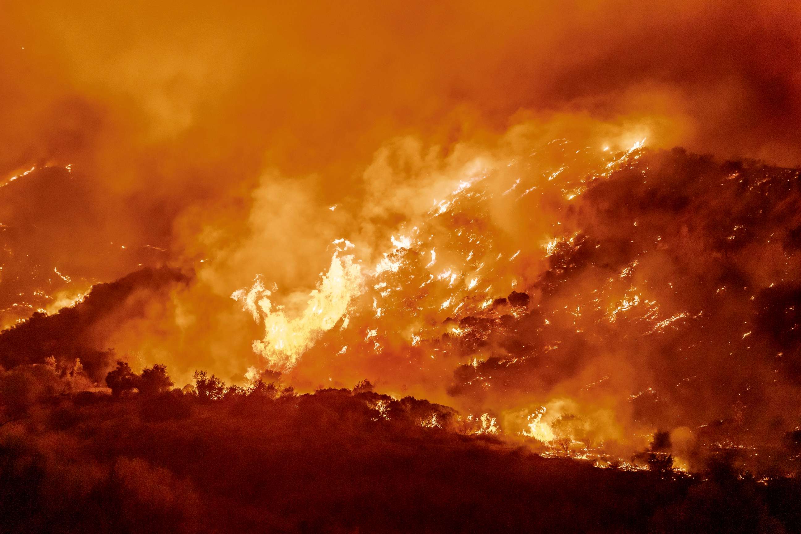 PHOTO: The Bond Fire driven by high winds burns the hillsides west of Santiago Canyon Road near Silverado Canyon, Calif., Dec. 3, 2020.