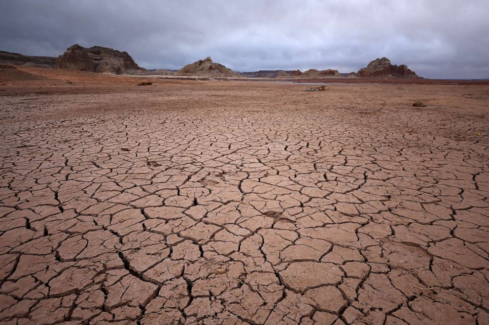 PHOTO: In this March 28, 2022, file photo, dry cracked earth is visible in an area of Lake Powell that was previously underwater, in Page, Ariz.