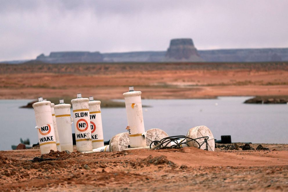 PHOTO: In this March 28, 2022, file photo, buoys sit on the beach near the Wahweap Marina at Lake Powell, in Page, Ariz.