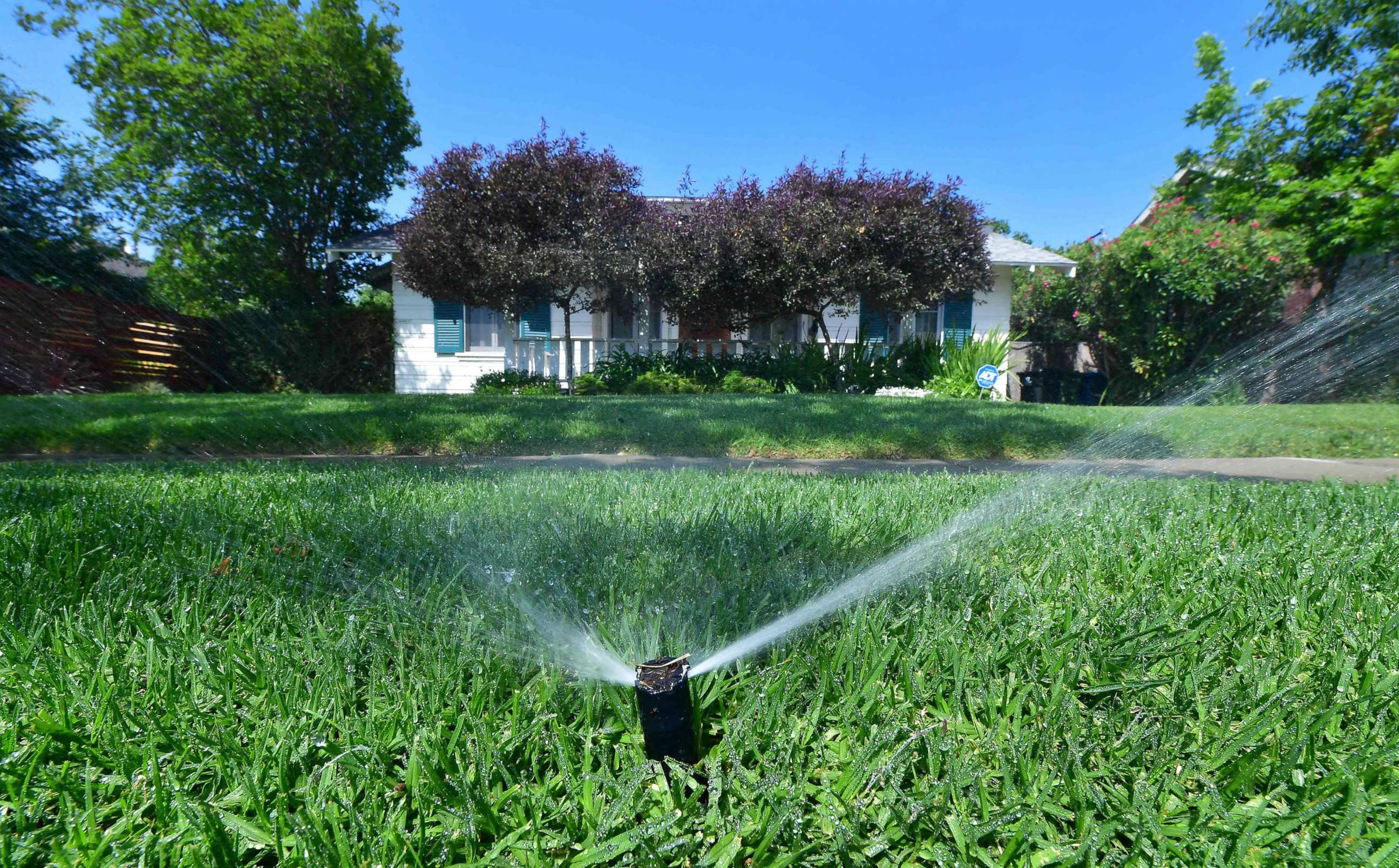 PHOTO: An automated sprinkler waters grass in front of homes in Alhambra, Calif., April 27, 2022, a day after Southern California declared a water shortage emergency.