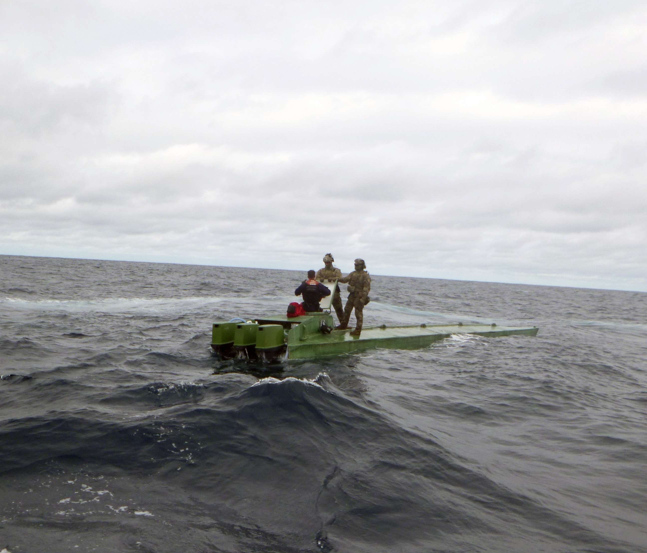 PHOTO: TTwo team members after intercepting a smuggler as part of the counter-narcotic efforts of operation MARTILLO in international waters off the coasts of Mexico, Central and South America.