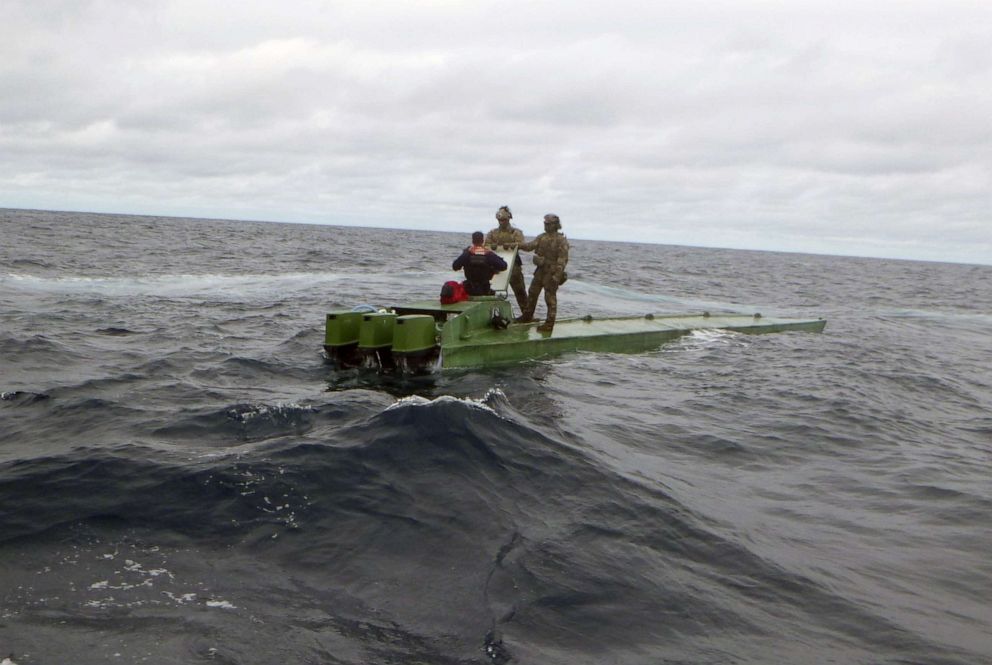 PHOTO: TTwo team members after intercepting a smuggler as part of the counter-narcotic efforts of operation MARTILLO in international waters off the coasts of Mexico, Central and South America.