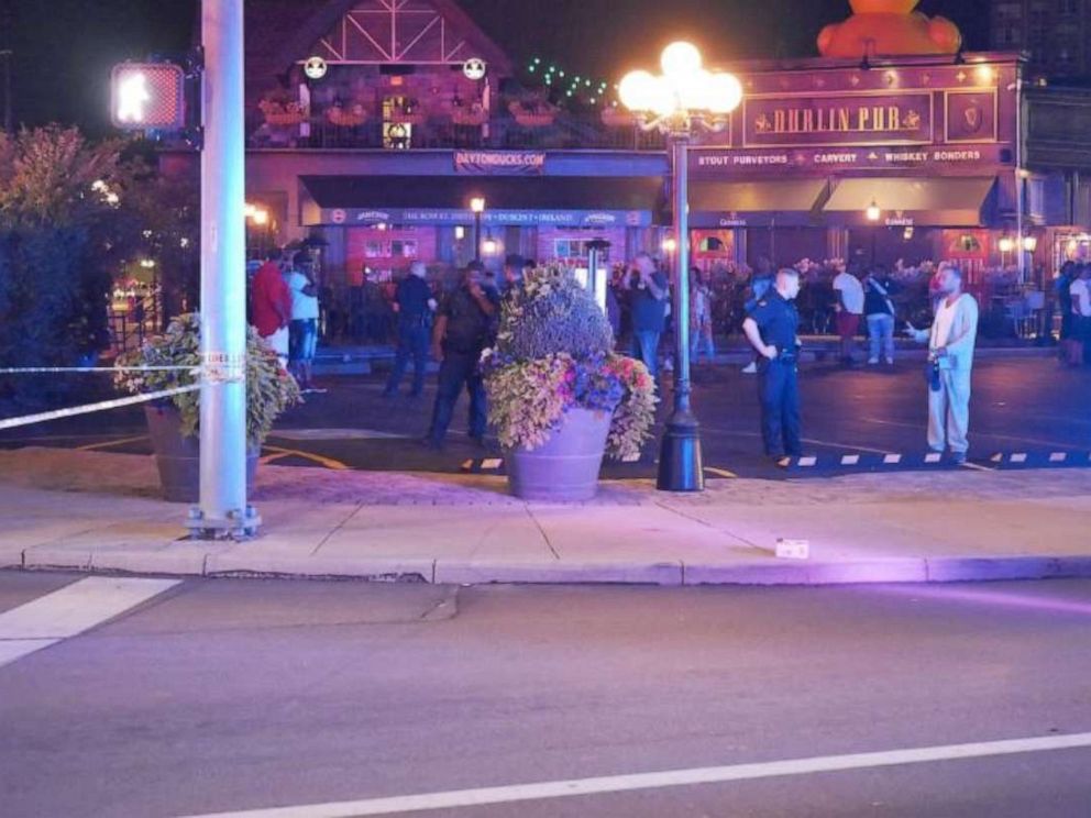 PHOTO: A large police presence stands outside the Dublin Pub in Dayton, Ohio, where a shooting happened in downtowns Oregon District in the early morning hours of Sunday, Aug. 4, 2019.