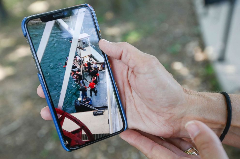 PHOTO: Sonja Malaske, of Harrah, Okla., shows a picture she took from the Branson Belle of people being pulled from the water after a duck boat capsized on Table Rock Lake in Branson, Mo., July 20, 2018.