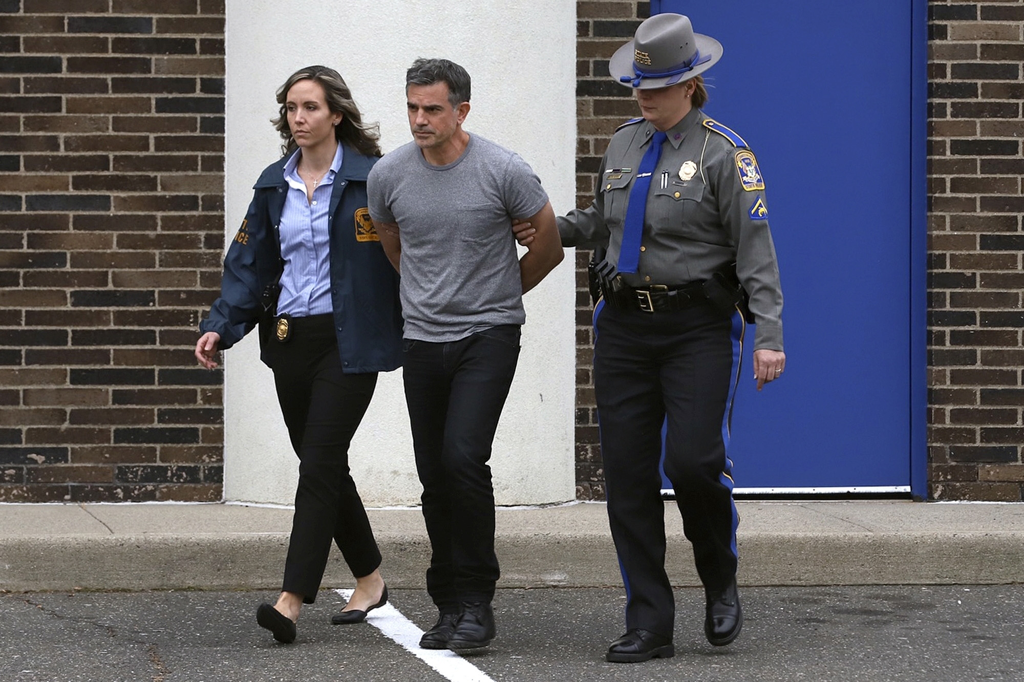 PHOTO: Connecticut State Police officers lead Fotis Dulos, center, from the State Police barracks to a waiting car, Jan. 7, 2020, in Bridgeport, Conn., after he was arrested at his home in Farmington.
