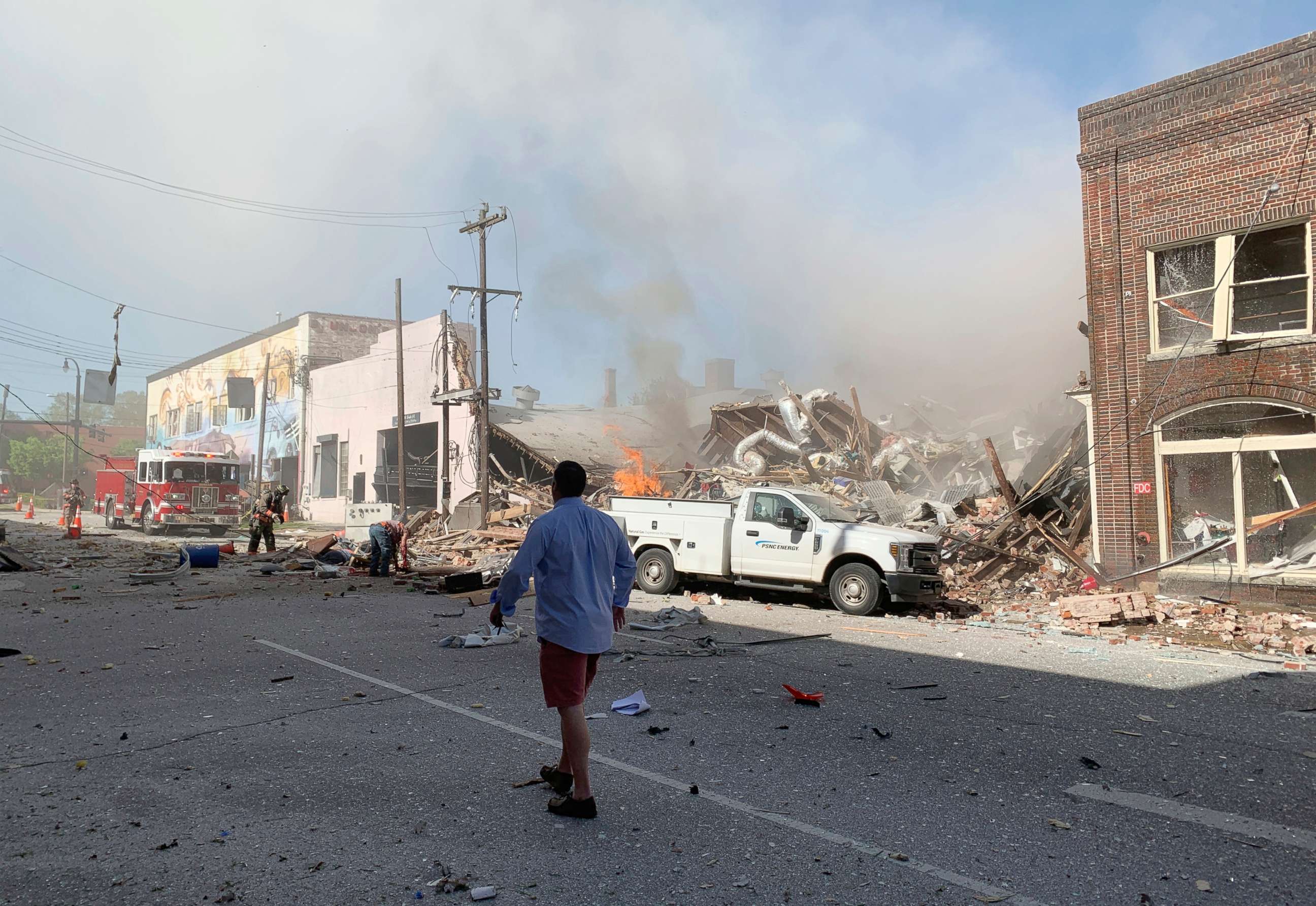 PHOTO: In this photo released by Jim Rogalski, firefighters help injured people after a building exploded, April 10, 2019, in Durham, N.C.