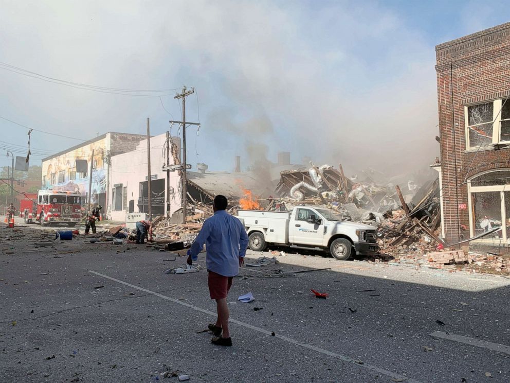 PHOTO: In this photo released by Jim Rogalski, firefighters help injured people after a building exploded, April 10, 2019, in Durham, N.C.