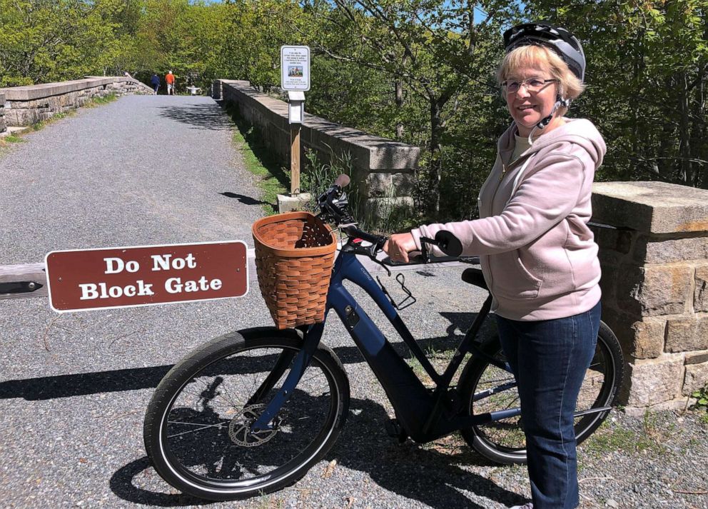 PHOTO: In this June 8, 2019 file photo, Janice Goodwin stands by her electric-assist bicycle at a gate near the start of the carriage path system where bikes such as her are banned inside Acadia National Park, in this photo June 8, 2018.