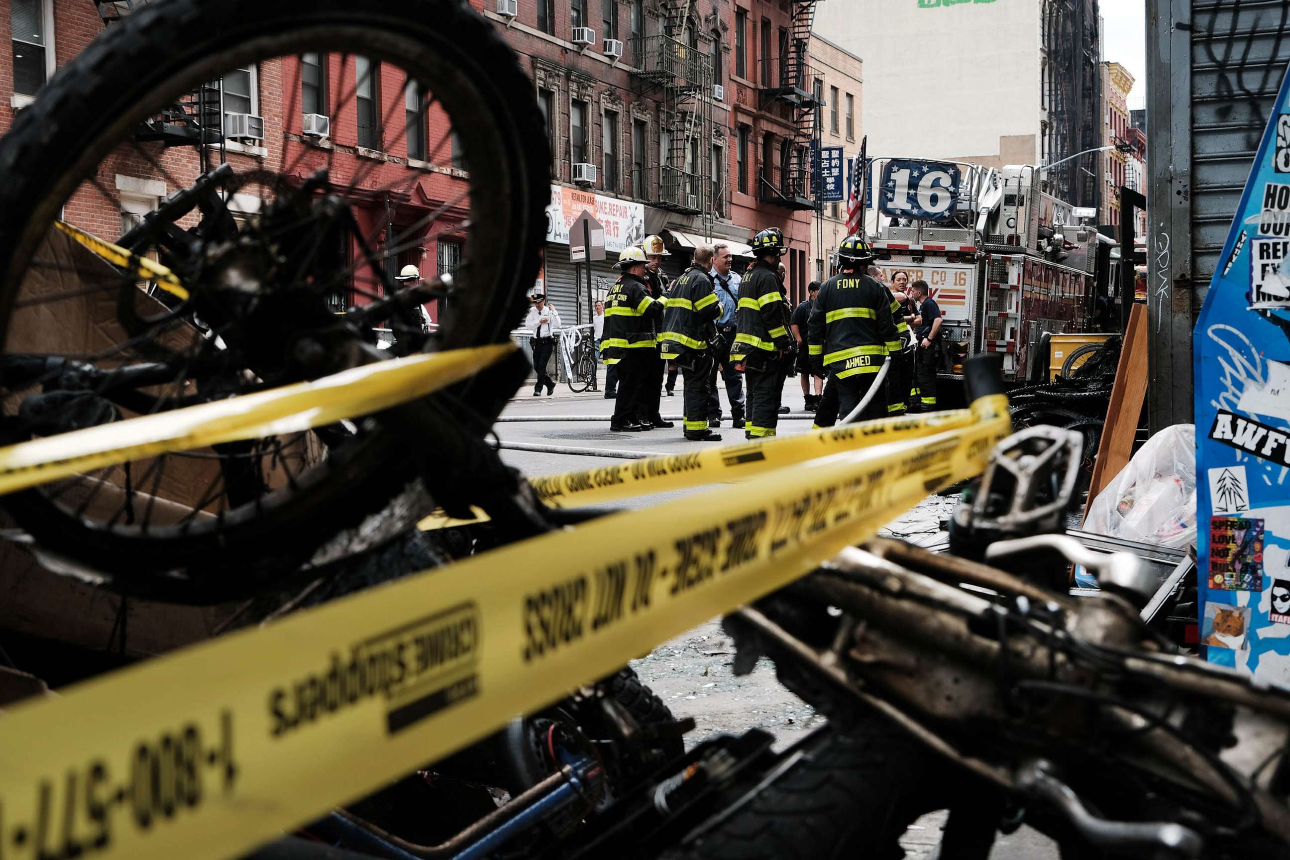PHOTO: Charred remains of e-bikes and scooters sit outside of a building in Chinatown after four people were killed by a fire in an e-bike repair shop overnight, June 20, 2023 in New York City.