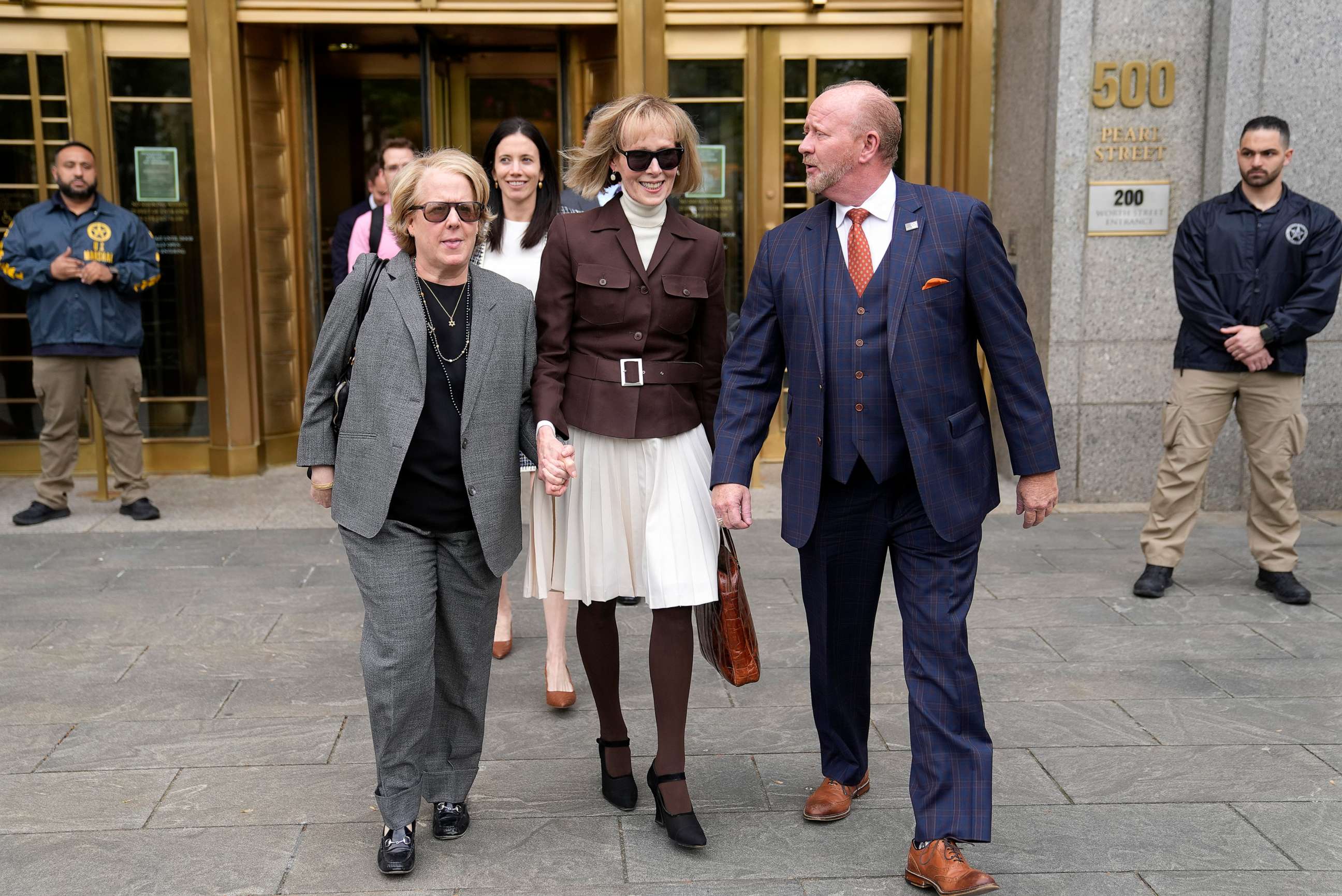 PHOTO: E. Jean Carroll, center, walks out of Manhattan federal court, on May 9, 2023, in New York.