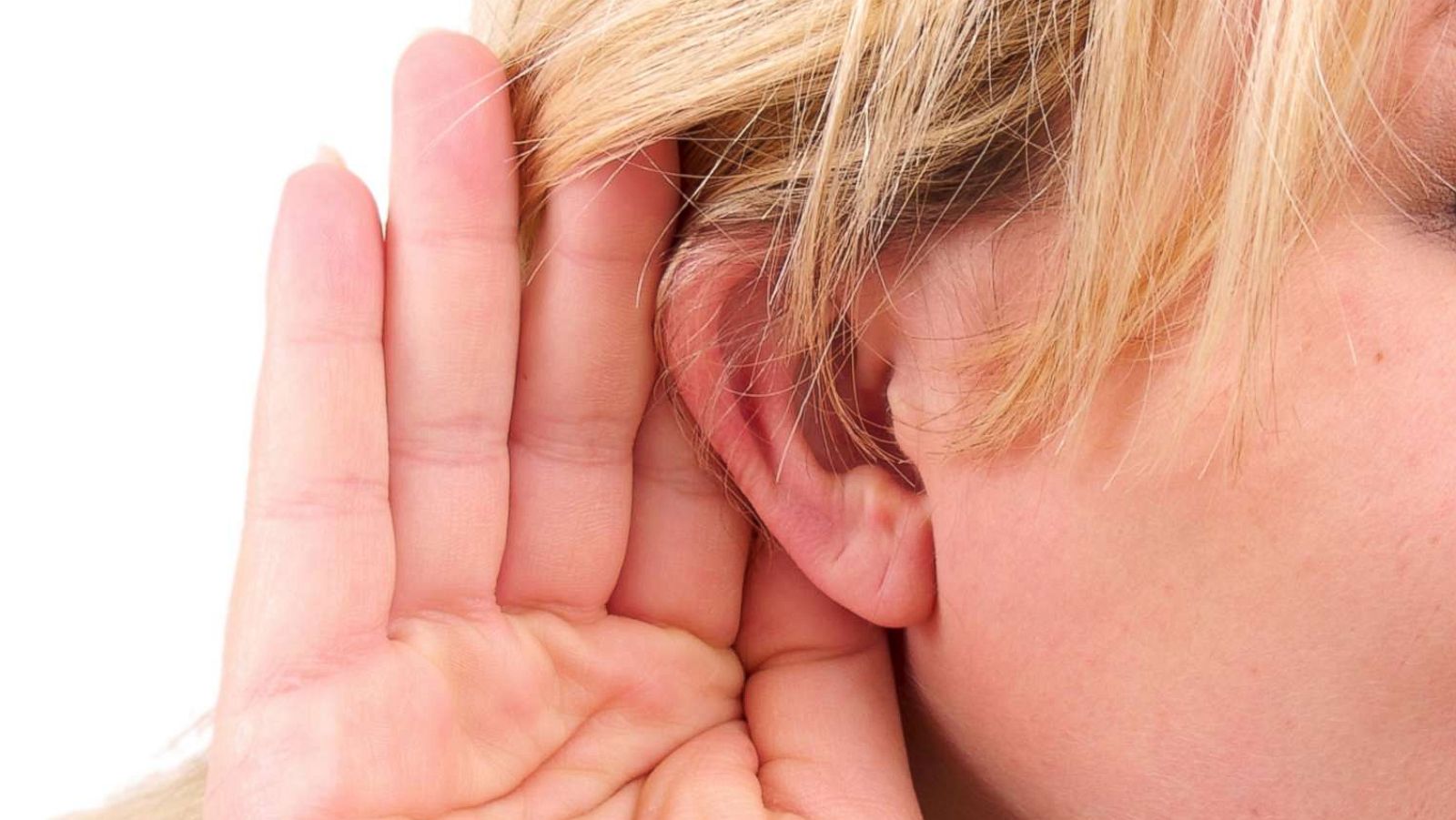 PHOTO: A woman holds a hand to her ear in an undated stock photo.