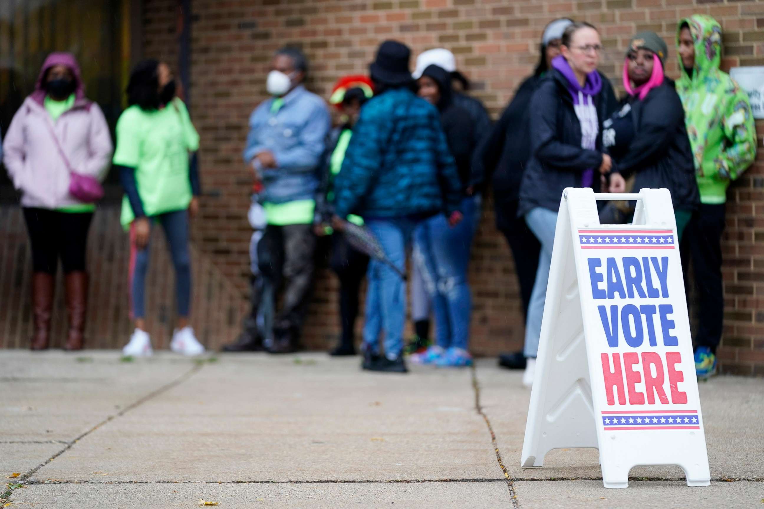 PHOTO: People line up outside a polling station to cast their votes on Oct. 25, 2022, in Milwaukee.