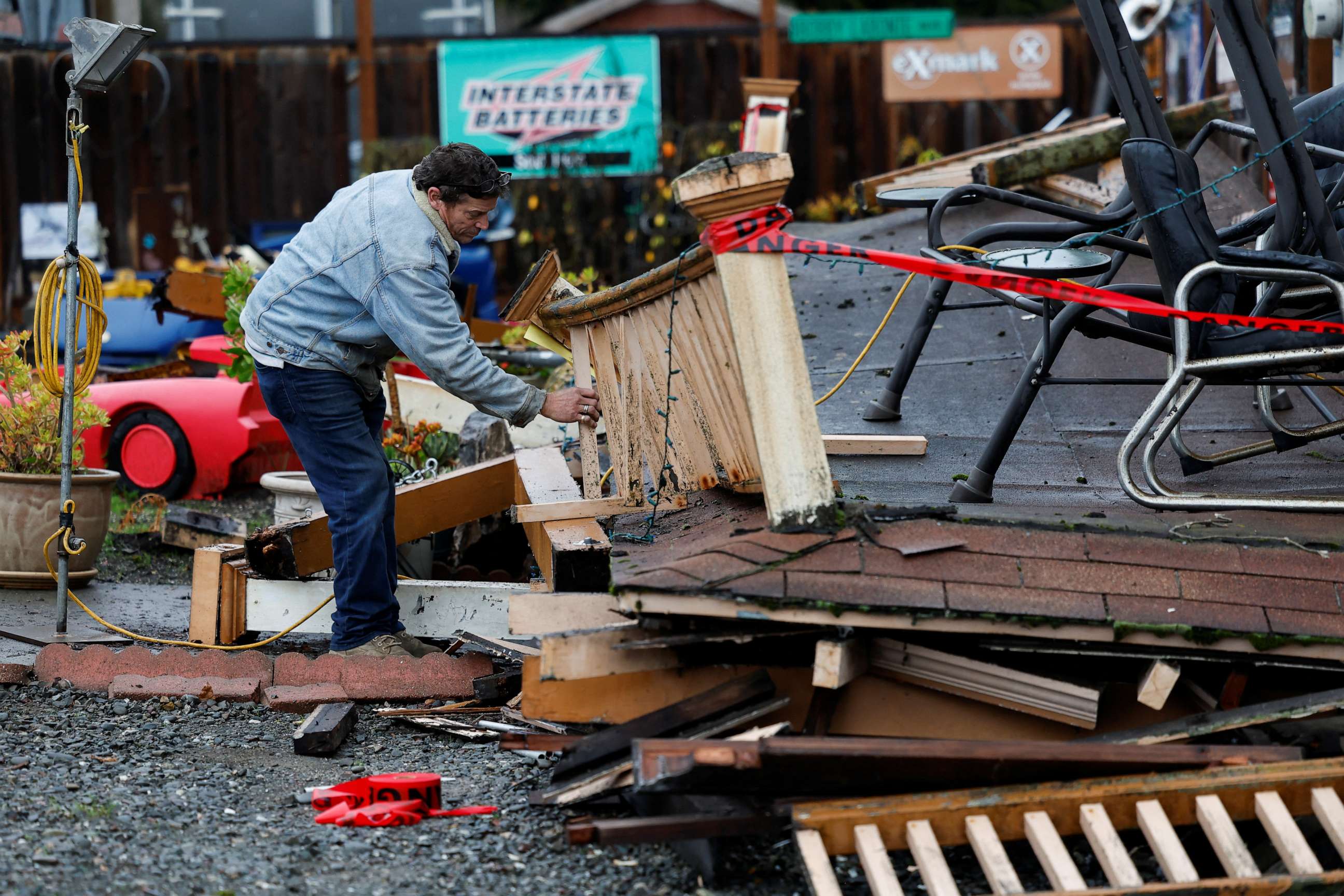 PHOTO: Homeowner Darren Gallagher inspects the collapsed second story porch of his house after a strong 6.4-magnitude earthquake struck off the coast of Northern California, in Rio Dell, Calif., Dec. 20, 2022.