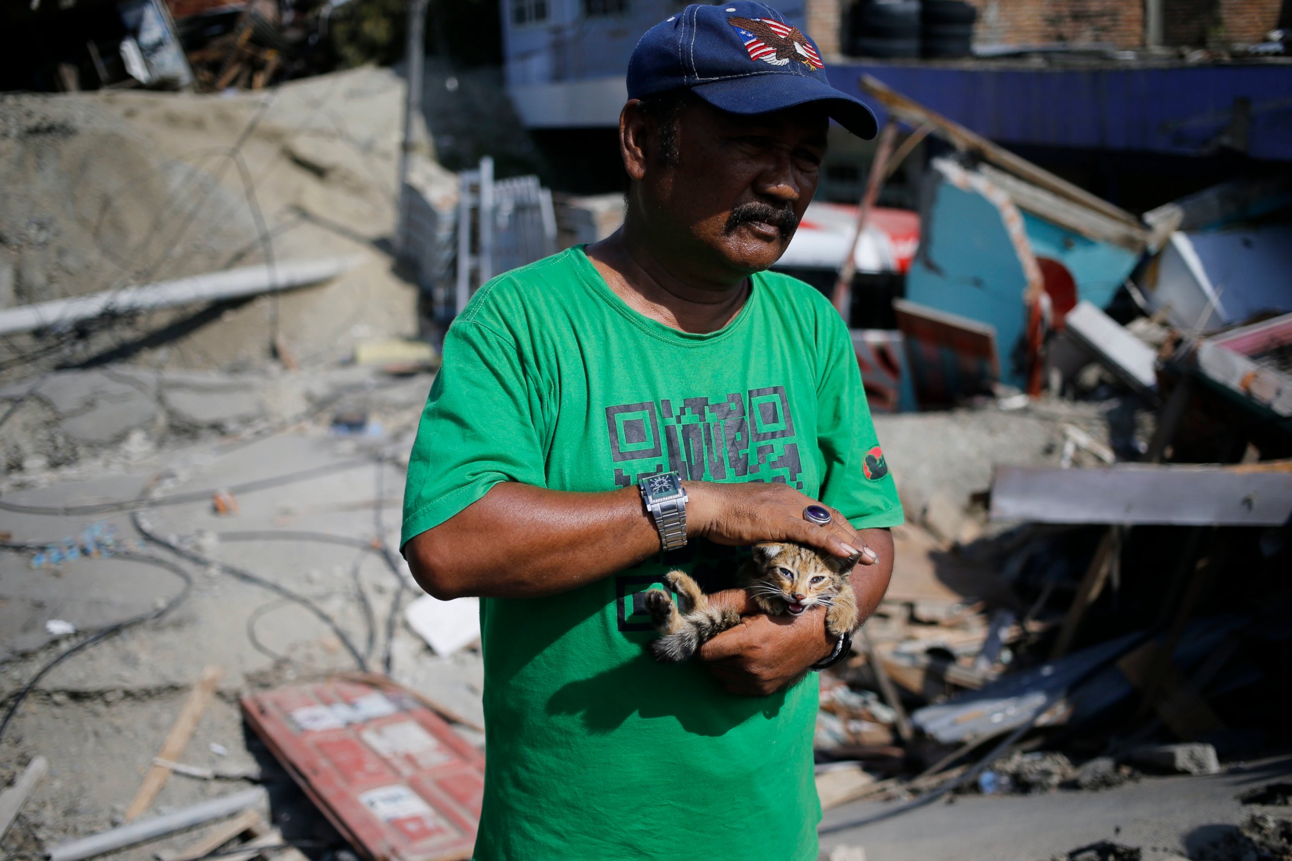 PHOTO: Sa'adon Lawira holds his grandson's cat whose miauw helped him finding his body which was buried under the rubble of the family's house in Balaroa neighborhood in Palu, Central Sulawesi, Indonesia Indonesia, Tuesday, Oct. 2, 2018.