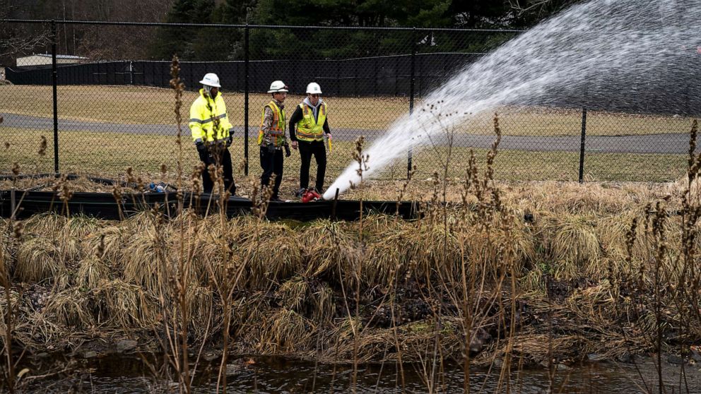 PHOTO: A clean-up crew works alongside a stream as clean-up efforts continue on Feb. 16, 2023, in East Palestine, Ohio. On Feb. 3rd, a Norfolk Southern Railways train carrying toxic chemicals derailed causing an environmental disaster.