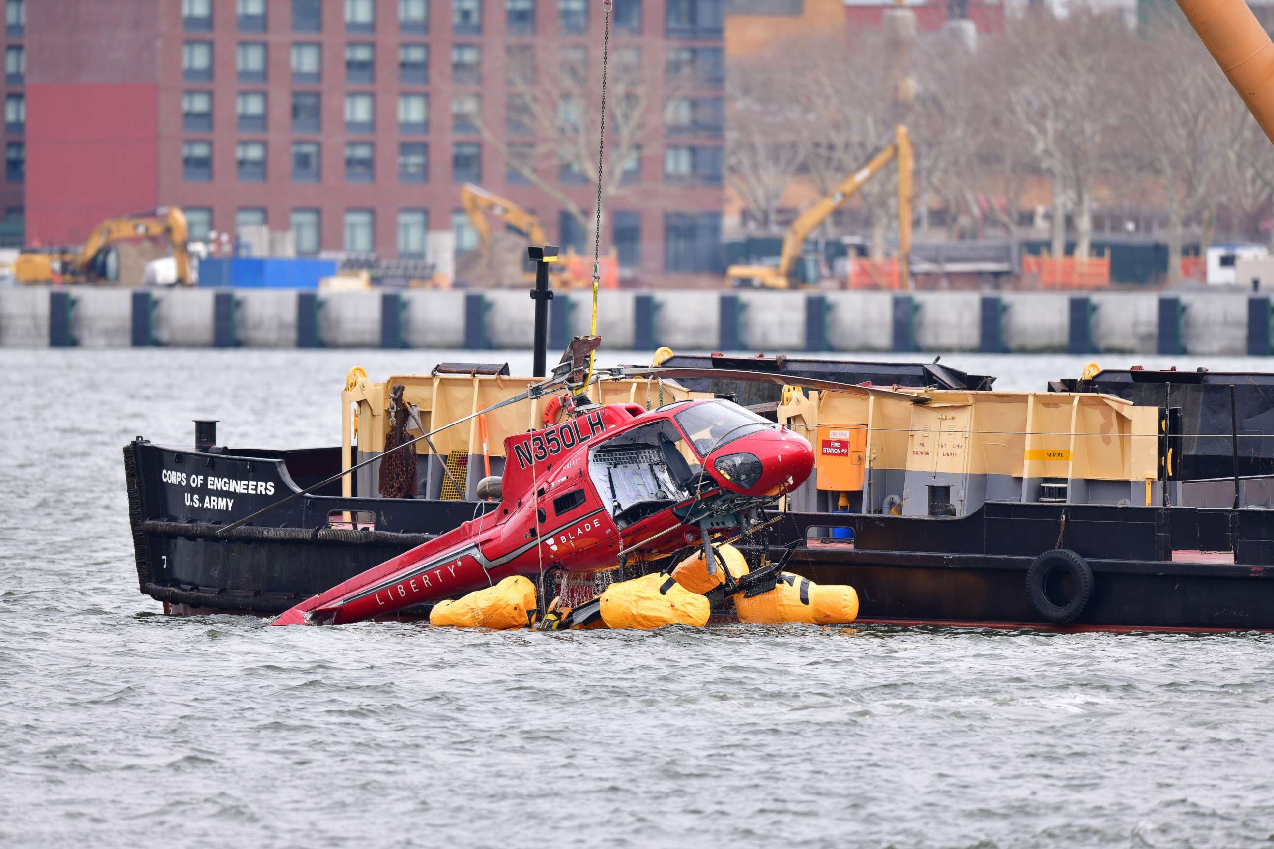 PHOTO: File photo of a helicopter being pulled from the East River on March 12, 2018, in New York City. Five people died after the helicopter made an emergency landing and flipped upside down trapping the passengers inside.