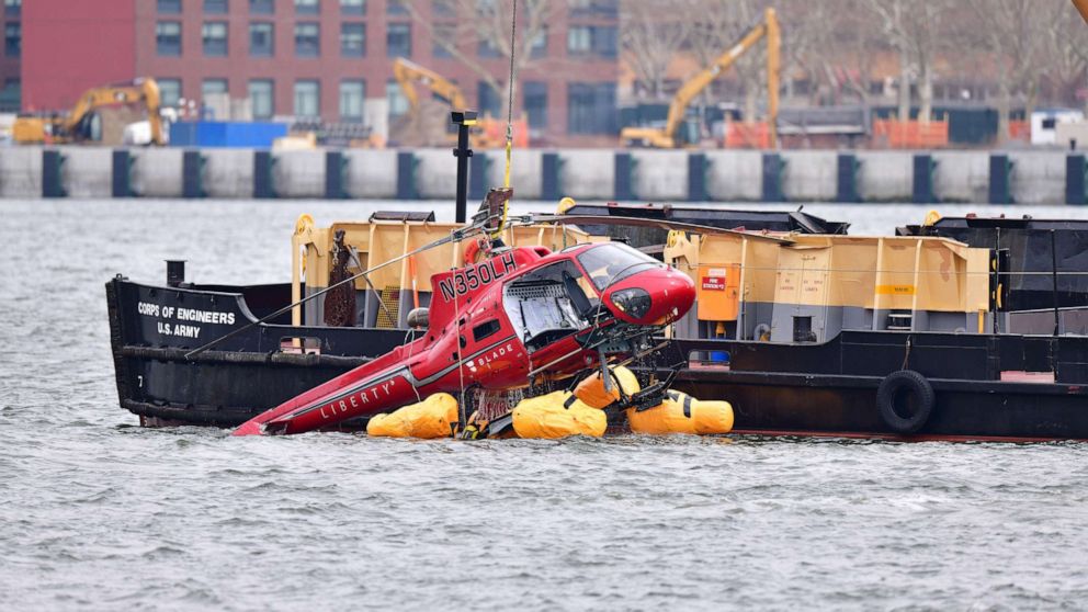 PHOTO: File photo of a helicopter being pulled from the East River on March 12, 2018, in New York City. Five people died after the helicopter made an emergency landing and flipped upside down trapping the passengers inside.