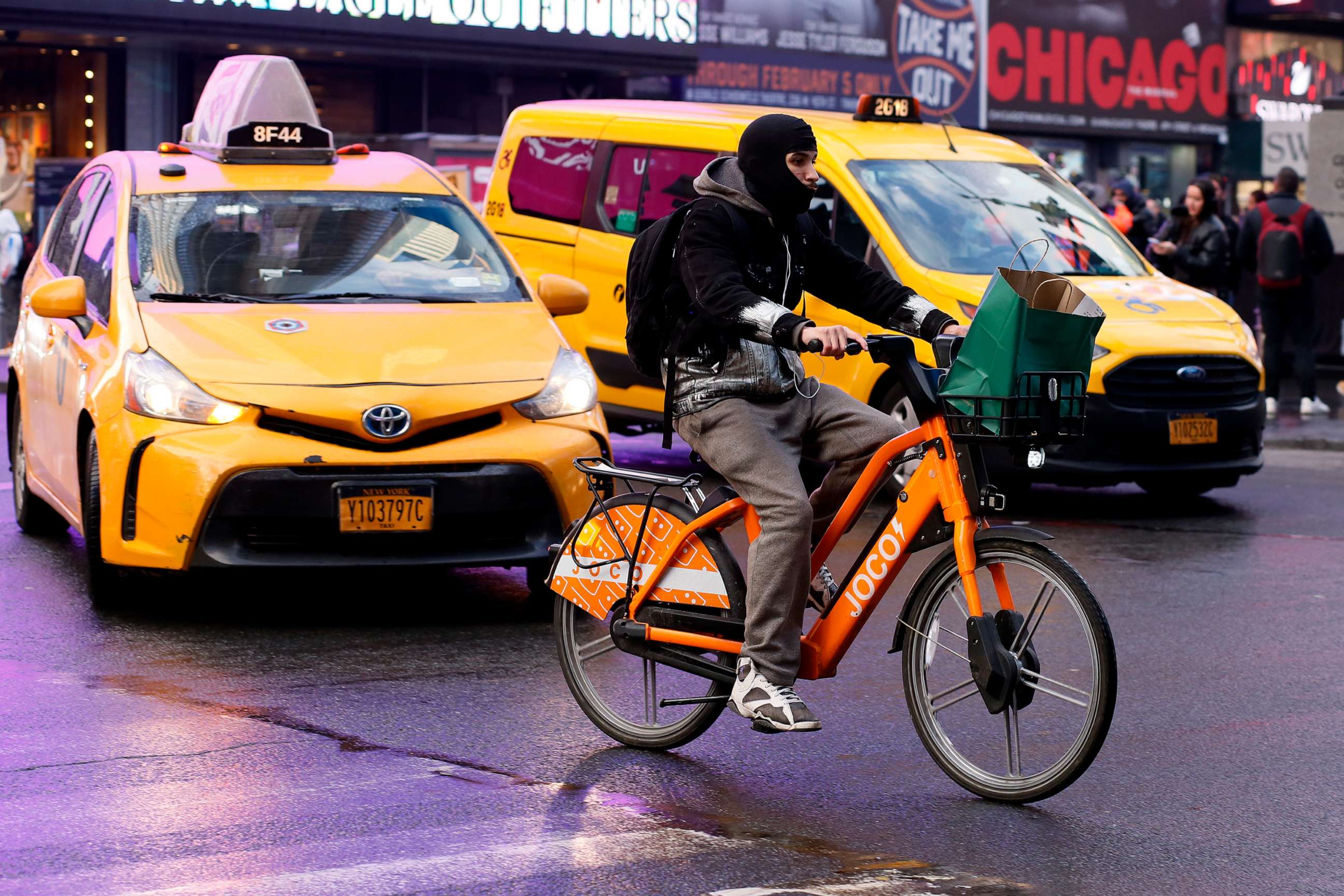 PHOTO: A man rides an e-bike through Times Square on Feb. 21, 2023, in New York.