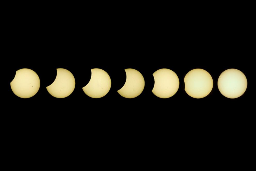 PHOTO: This combined photo shows the process of the partial solar eclipse observed at the University of the Philippines in Quezon City, the Philippines, April 20, 2023.