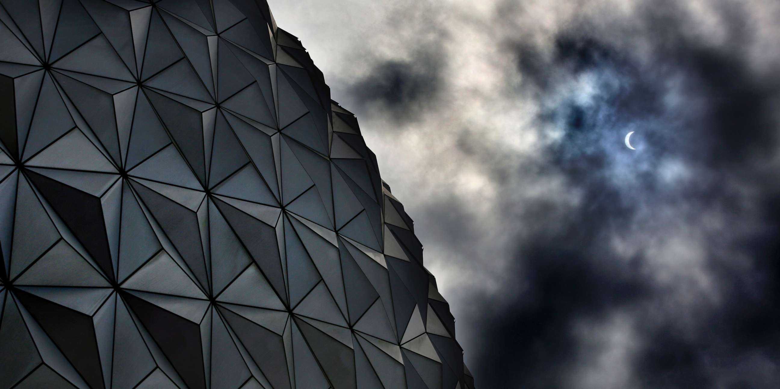 PHOTO: Rain clouds obscure the solar eclipse tracking over Spaceship Earth at Epcot at Walt Disney World in Lake Buena Vista, Florida, Aug. 21, 2017.